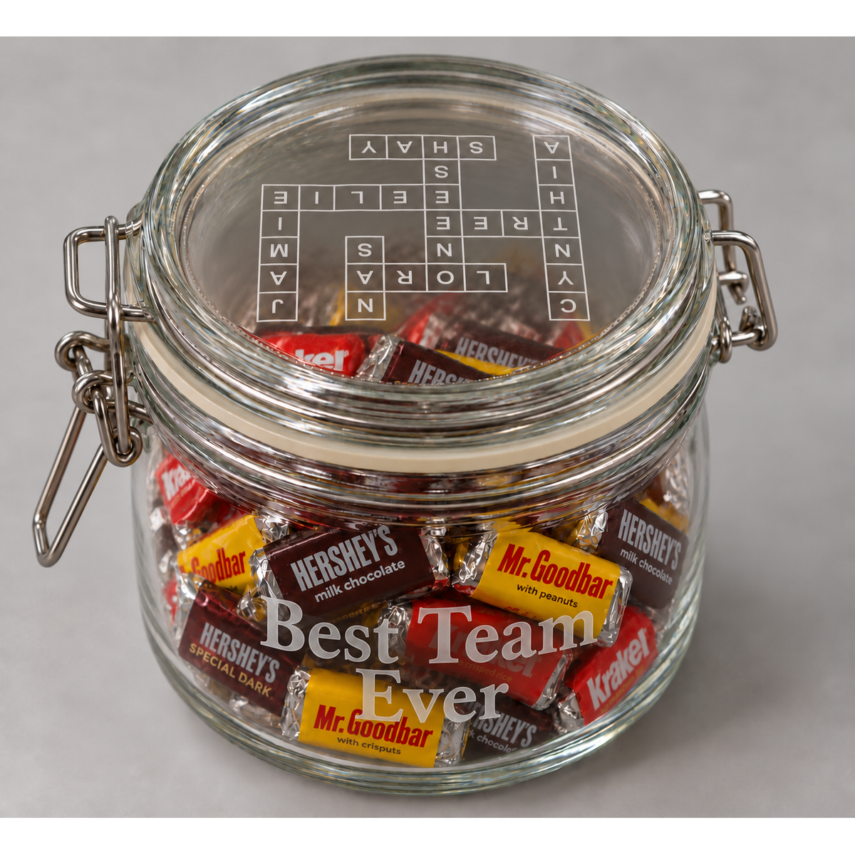 Opposite side of personalized candy jar engraved Best Team Ever; crossword lid includes Cynthia.